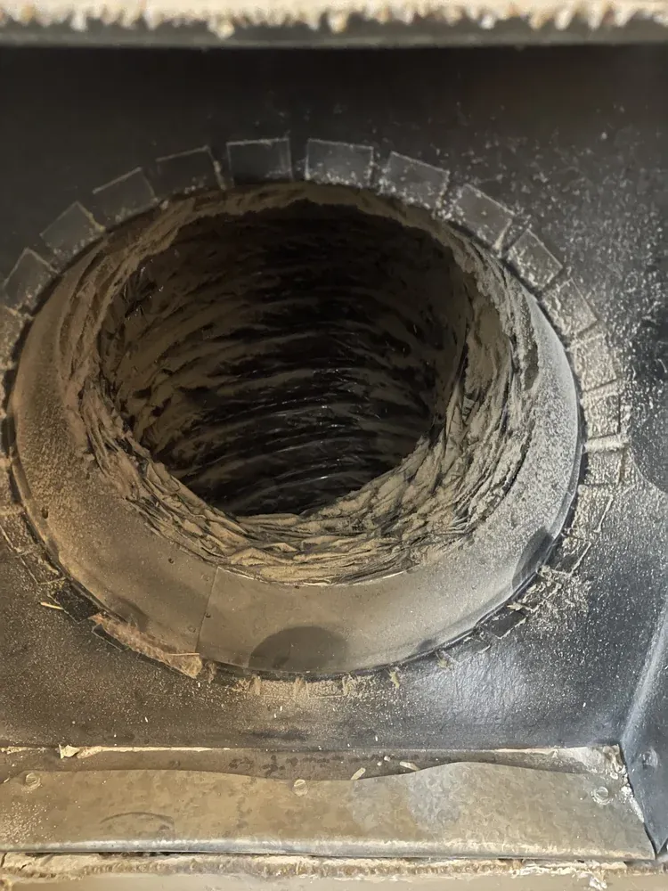 Air duct with dust and debris buildup before cleaning by Davinci Home Improvements