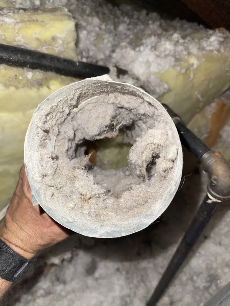 Dryer vent duct packed solid with lint before cleaning by Davinci Home Improvements